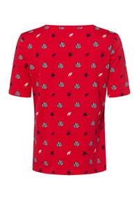Red short-sleeve t-shirt featuring a pattern of black and white seashells, starfish, and lips. Made of soft cotton fabric. Round neckline.