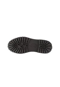 Suela de zapato de goma negra con un dibujo de logo en el centro. Texturizada con surcos y estrías para proporcionar tracción.