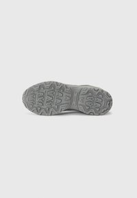 Gray athletic shoe outsole with a rugged, textured pattern and traction details. Features a smooth, reinforced heel area and flexible design.