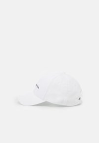 White cotton baseball cap with adjustable back strap, curved visor, and embroidered logo on the front for identifiable branding.