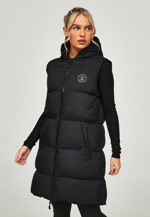 Black padded vest with a hood, front zipper, and logo detail. Features side pockets and a quilted design for insulation.
