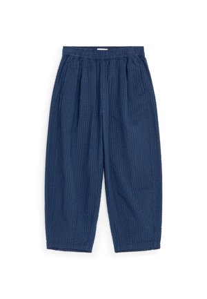 Pantalon bleu marine ample avec une taille élastique et un tissu texturé, présenté sur fond blanc.