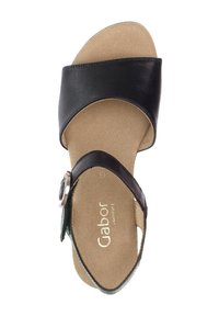 Black leather sandal with a cushioned beige insole, featuring two straps and a silver buckle detail on the side.