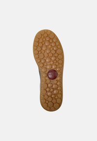 Rubber outsole with a textured pattern of bubbles; colored in tan with a red logo. Size indicated as 42.