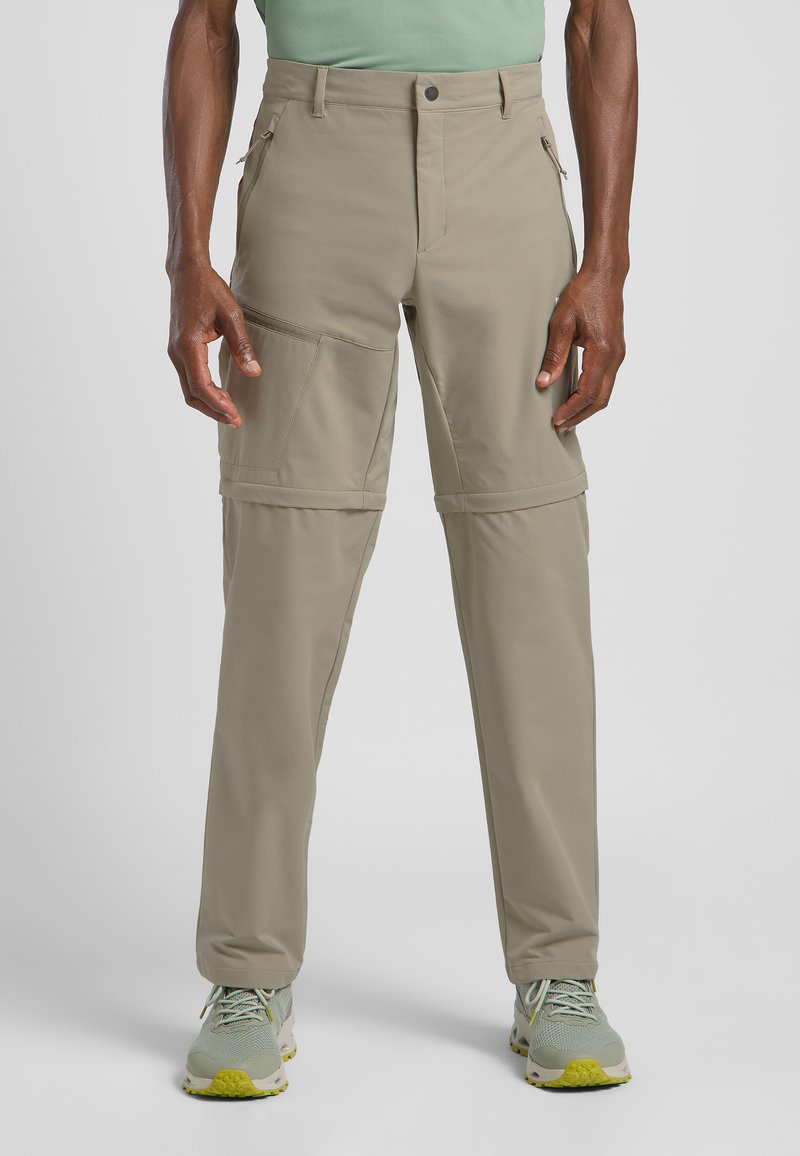 Beige, leichte Wanderhosen mit Reißverschlusstaschen und abnehmbaren Beinen. Aus strapazierfähigem Material gefertigt, das für Vielseitigkeit bei Outdoor-Aktivitäten entwickelt wurde.