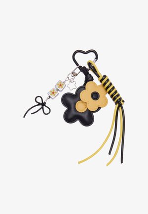 Sort og gul blomster-nøglering med hjerteformet clips, blomsterformede charms, perledetalje og knyttede snorekvaster.