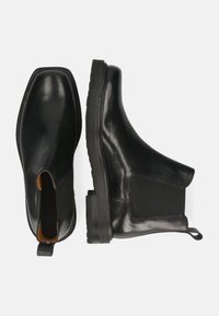 Stivaletti Chelsea in pelle nera con pannelli laterali elastici, punta quadrata e suola in gomma testurizzata. Dotati di linguetta per facilitare la calzata.