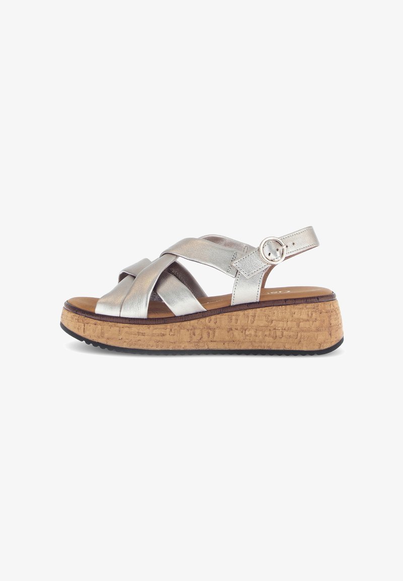 Silver metallic strappy sandals with a cork platform, featuring a rounded toe and adjustable ankle strap. Textured cork finish.