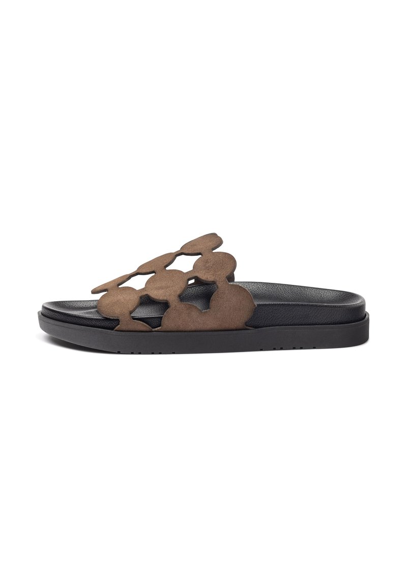 Brown suede slide sandals with a cut-out circular pattern on the strap, resting on a black textured sole with a slight platform.