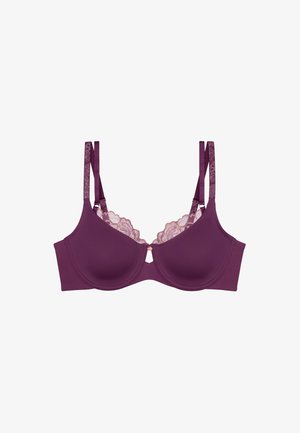 Soutien-gorge bleu violet avec dentelle, présentant un design lisse, des bonnets moulés, un élément décoratif au centre et des bretelles doubles réglables pour un meilleur maintien.