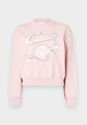 Roosa lühendatud dressipluus, millel on graafiline disain sõnaga "Coach" ja kommi motiiviga, valmistatud pehmest kangast, millel on soonikkoes varrukaotsad ja alläär.