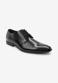 Black leather dress shoes with a smooth finish, pointed toe, and a textured panel on the sides. Features lace-up closure and low heel.