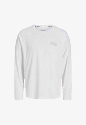 Camisa blanca de manga larga confeccionada en una tela ligera. Presenta mangas raglán y un pequeño logo impreso en el pecho. Textura suave.