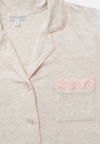 Light gray pajama top with pink piping and lace-trimmed pocket. Features a classic collar and button closure. Soft, smooth texture.