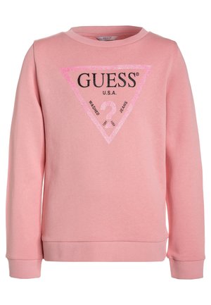 Sweatshirt rose à col rond. Présente un logo triangulaire noir et pailleté rose avec "GUESS U.S.A." et du texte. Poignets et ourlet côtelés.