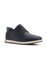 Navy blue casual shoe with textured synthetic upper, lace-up design, white midsole, and rubber brown outsole. Leather accent at heel.