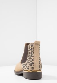Stivale alla caviglia in suede tan con accentuazioni in stampa leopardata, pannelli laterali elastici, hardware dorato e tacco a blocco marrone basso.