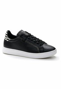 Black sneaker with textured upper, metallic accents, and patterned heel. Features a white rubber sole and traditional lace closure.