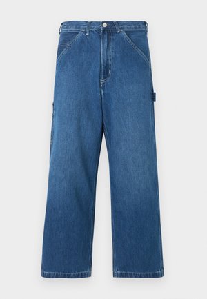 Modré široké džínsové nohavice s predným zapínaním na gombíky a zips, predné vrecká pod uhlom a detail bočného pútka.