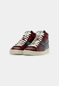 High-top sneakers in burgundy leather with light blue accents, featuring white laces and a textured cream rubber sole.