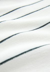 White fabric with soft texture, featuring dark blue horizontal stripes. The material appears smooth and pliable, highlighting the pattern's subtle contrast.