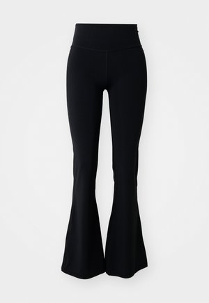 Leggings negros acampanados con una cintura alta, hechos de una tela suave y elástica. Las piernas se ensanchan gradualmente desde la rodilla hasta el dobladillo.