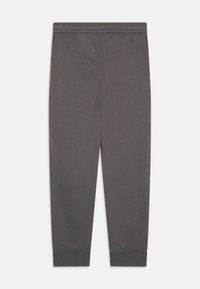 Pantalons de survêtement gris en tissu doux, avec une taille élastique, des poignets côtelés et une texture lisse sans motifs ni embellissements.