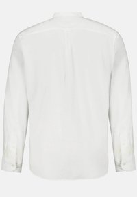 Camisa blanca de manga larga con una textura suave, puños con botón y un pliegue central en la parte posterior para un mejor ajuste. Tela suave con un diseño minimalista.
