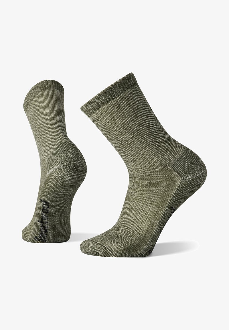 Olivgrüne, gerippte Socken mit verstärkter Ferse und Spitze. Das Material wirkt strukturiert und verfügt über einen glatten, elastischen Bund für einen sicheren Sitz.
