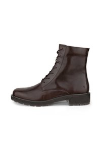 Stivaletto in pelle marrone con finitura liscia, punta rotonda, chiusura con lacci, altezza alla caviglia e suola in gomma testurizzata con trazione.