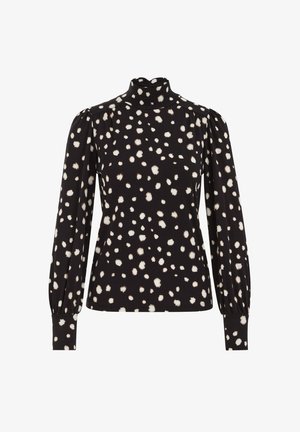 Top negro de manga larga con cuello alto, estampado de lunares blancos irregulares, hombros abullonados y puños ajustados.