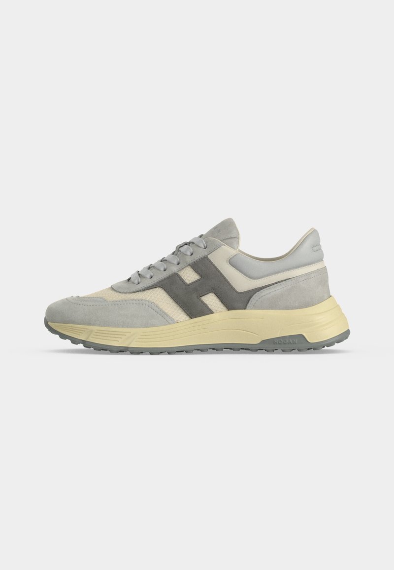 Light gray and beige suede sneaker with gray "H" logo on side and cream-colored sole on white background, viewed from left side.