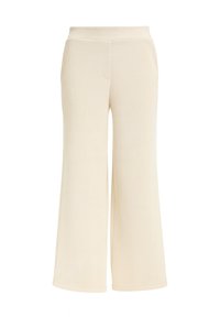 Beige gerippte weit geschnittene Hosen mit elastischem Bund. Weiche Textur und glatte Oberfläche. Keine sichtbaren Taschen oder Hardware-Details.