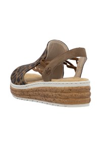 Leopard print wedge sandal with brown suede accents, open sides, and a cork platform. Features a white sole and lace detail on the back.
