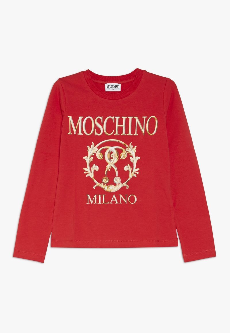 Red long-sleeve t-shirt made of cotton, featuring a gold Moschino logo and ornate design elements printed on the front. Round neckline.