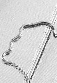 Ezüst bőr pénztárca texturált felülettel, hullámzó mintájú fém cipzár díszítéssel és a széleken sima cipzár díszítéssel.