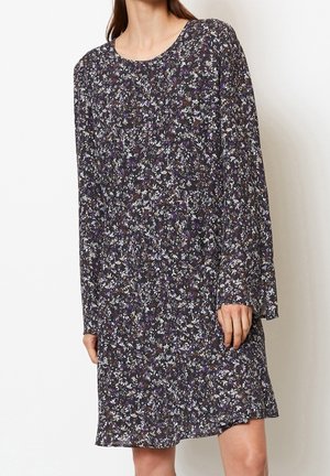 Robe à manches longues à motifs floraux avec un fond violet foncé et de petites fleurs blanches et violettes. Coupe ample avec un col rond.