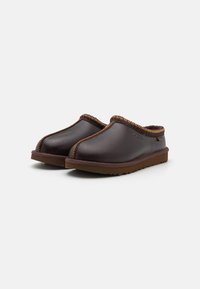 Brown leather slip-on clogs with a braided brown accent on the upper edge and a textured brown rubber sole.