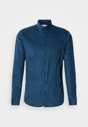 Button-up shirt in dark blue cotton fabric. Features long sleeves, a pointed collar, and black buttons along the front placket.