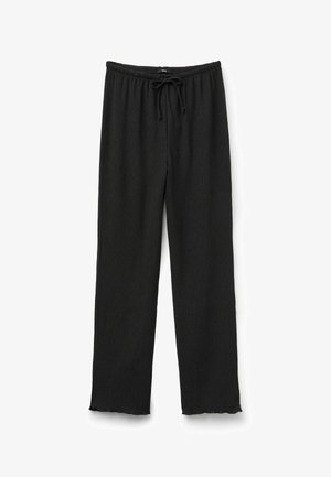 Pantalones negros plisados con cintura elástica y cordón. El dobladillo tiene un acabado ondulado y la tela presenta una apariencia texturizada.
