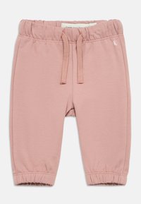 Gaiši rozā sporta bikses ar mīkstu tekstūru, elastīgu jostasvietu un aukliņu, ar savāktiem piedurknēm un nelielu logotipa akcentu.