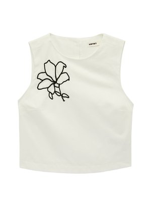 Top corto blanco sin mangas con cuello redondo y diseño floral delineado en negro en el hombro izquierdo.