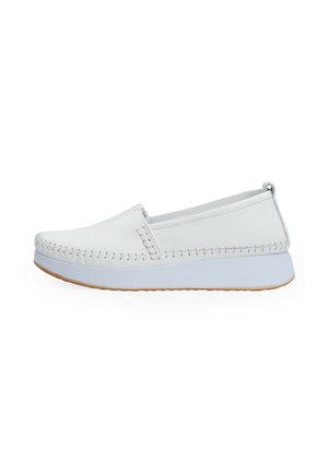 White slip-on shoe with stitched details, thick white sole, and light brown bottom, shown from the side on a white background.