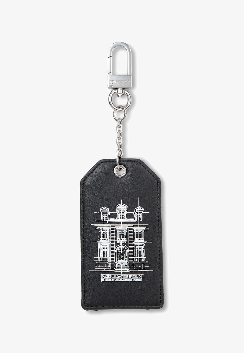 Porte-clés rectangulaire noir avec fermoir et chaîne argentés, avec un croquis architectural blanc d’un bâtiment et le texte « KARL LAGERFELD » en dessous.