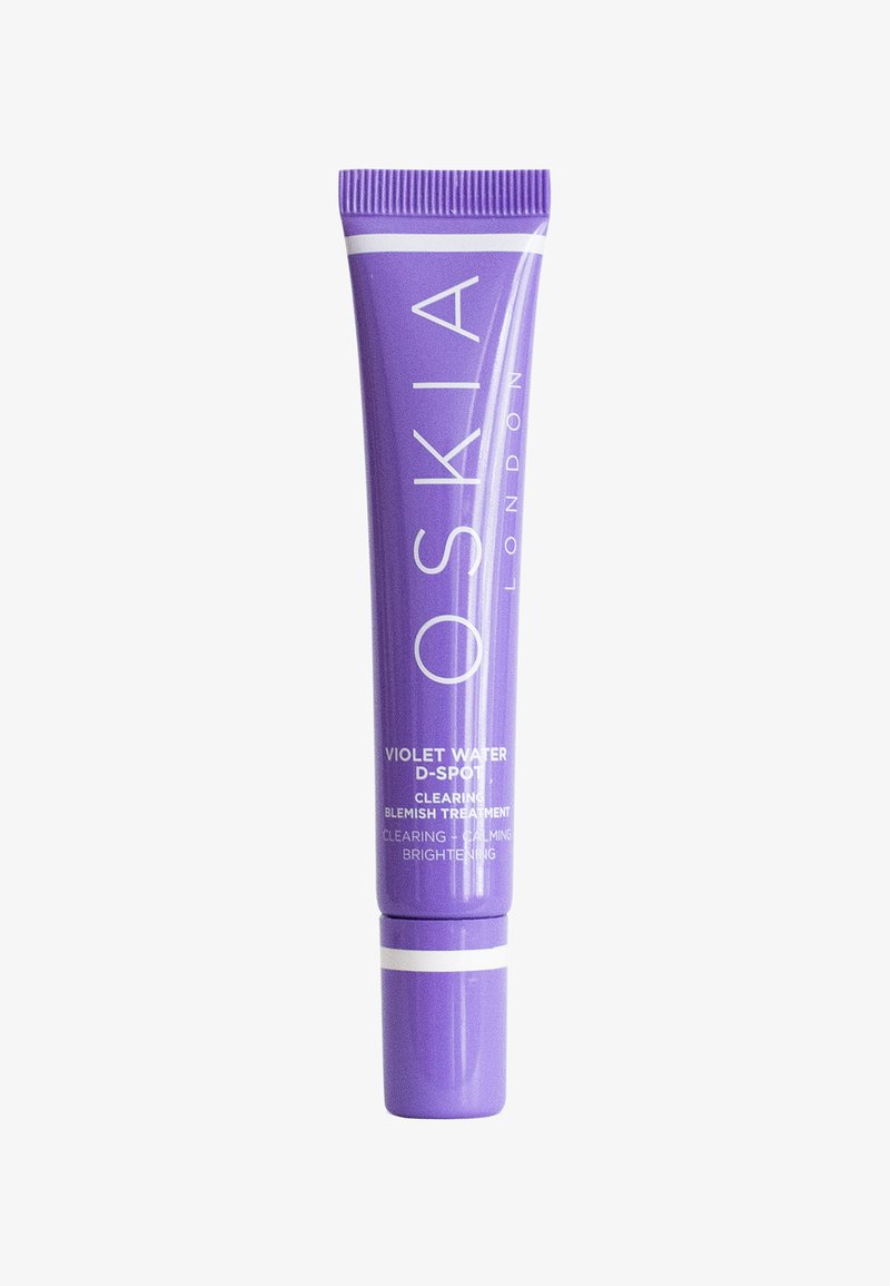 Tube souple violet avec un bouchon blanc, présentant le logo "OSKIA LONDON" et des détails du produit en texte blanc. Traitement anti-imperfections pour l'éclat.