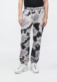 Φόρμες με σχέδιο tie-dye σε αποχρώσεις του γκρι, μαύρου και κρεμ, με ελαστική μέση και στενή εφαρμογή στους αστραγάλους· απαλό ύφασμα.