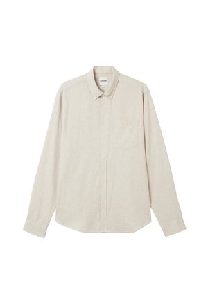 Chemise à manches longues beige clair, boutonnée, fabriquée en tissu texturé. Elle présente un col, une poche avant et un motif subtil.