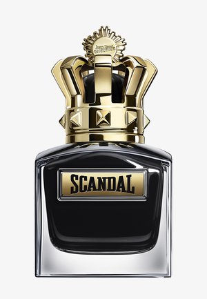 Perfume bottle labeled "SCANDAL" with black liquid inside and a gold crown-shaped cap featuring decorative studs and an emblem.