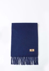 Navy blue wool scarf with fringed edges and a tan leather label featuring embossed logo. Soft texture, rectangular shape.