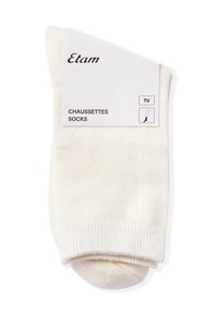 Calzini di cotone color crema con polsini a coste, dotati di una cucitura piatta e di un'etichetta che riporta il marchio "Etam" e le informazioni sulla taglia.